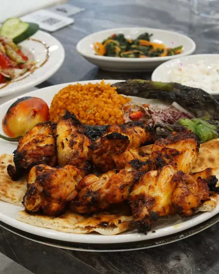Lavaş üstünde tavuk şiş, bulgur pilavı ve közlenmiş biber